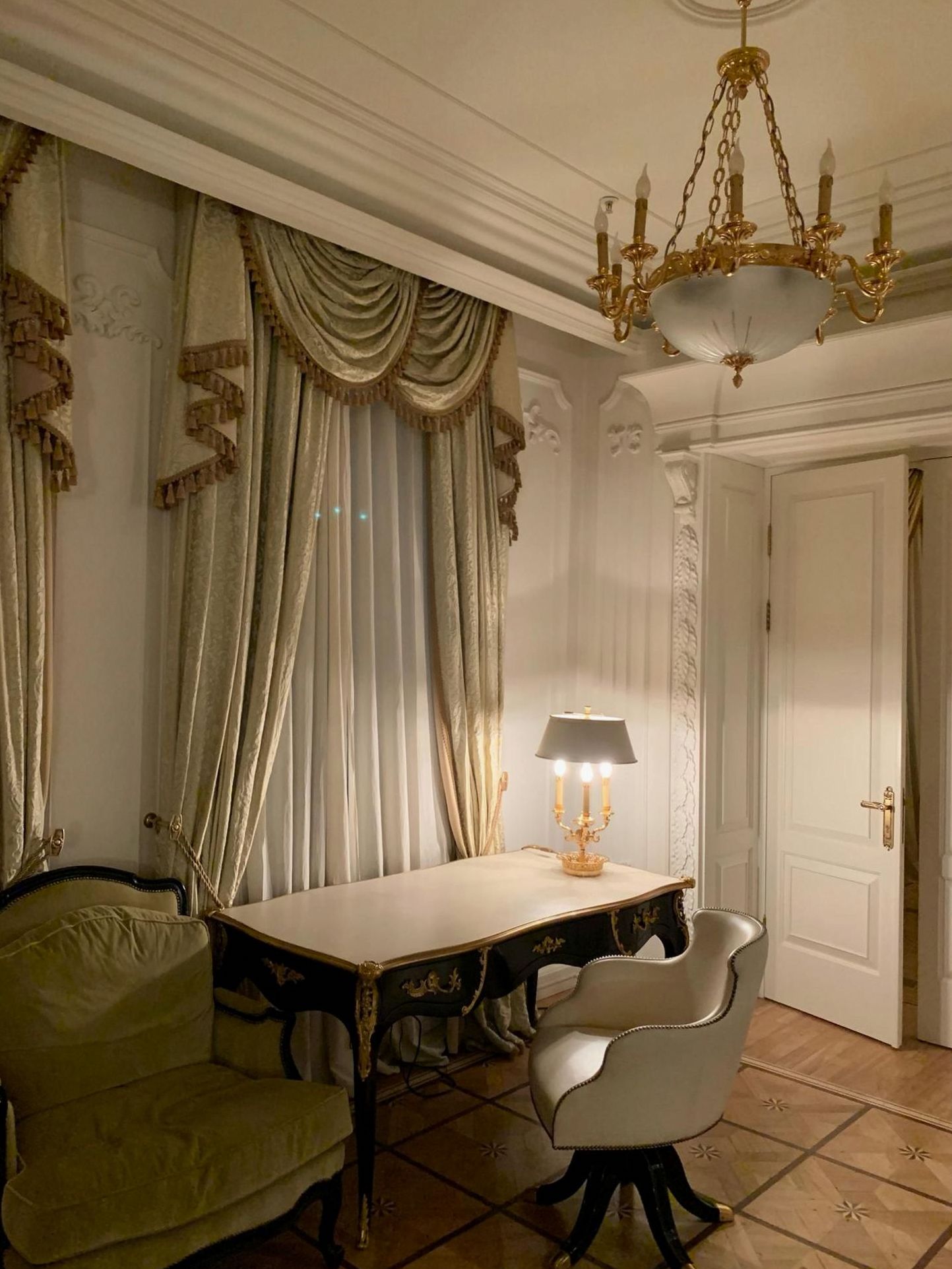 Classic chandelier and ornate curtains