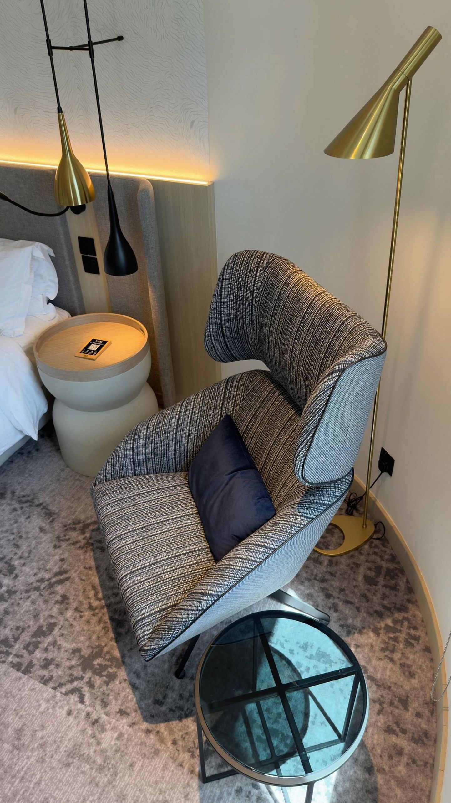Modern hotel room decor with gold lamp