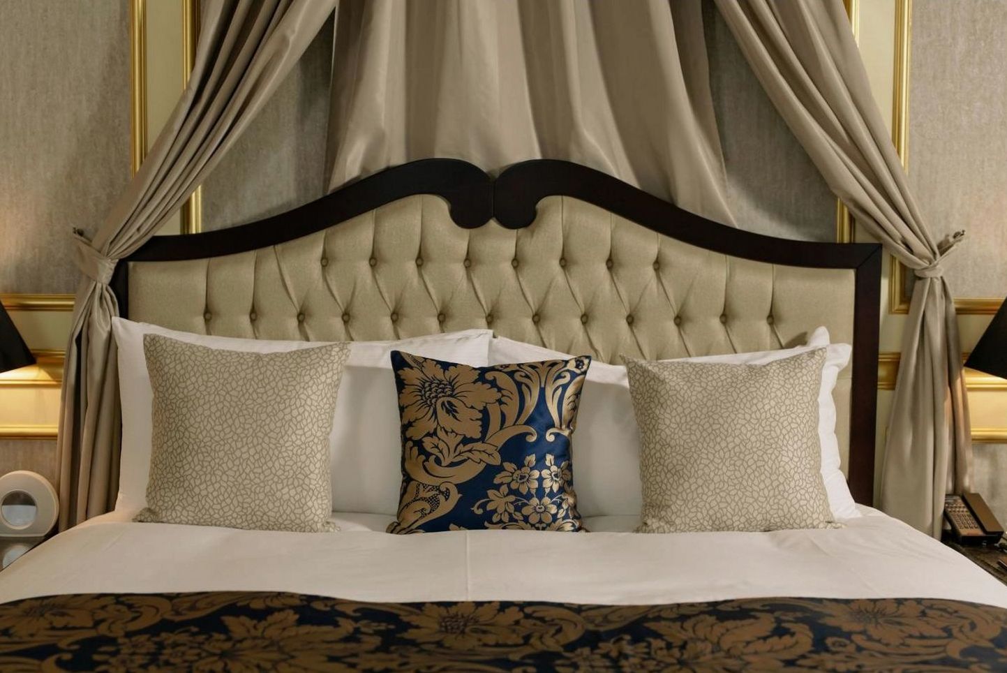 Elegant Golden Moments Hotel suite with plush bedding and warm lighting